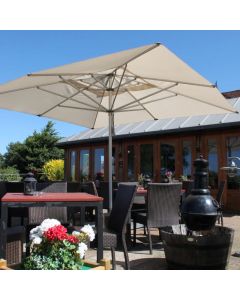 all weather parasol on a restaurant terrace shading a square table with chairs 